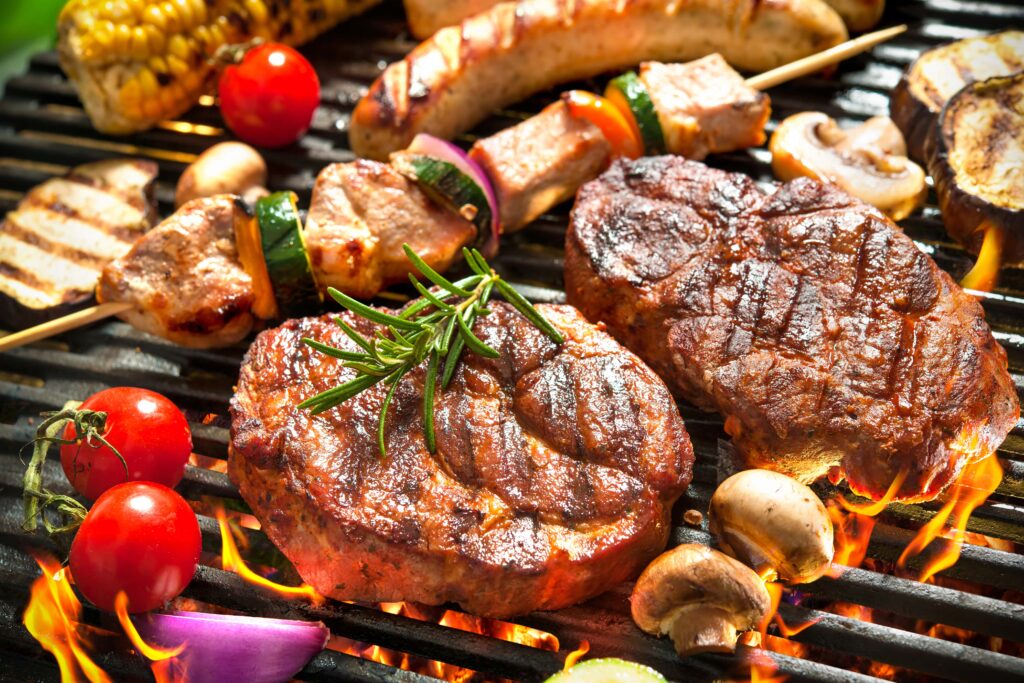 Meat, veggies, and mushrooms on grill