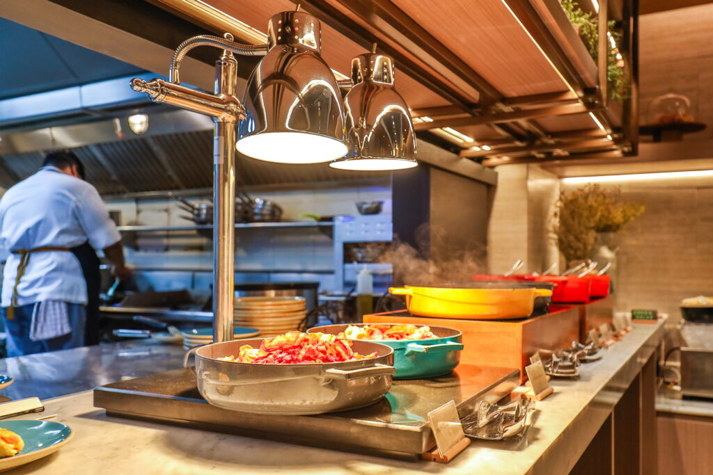 Commercial Kitchen, dishes lined up, chef in background
