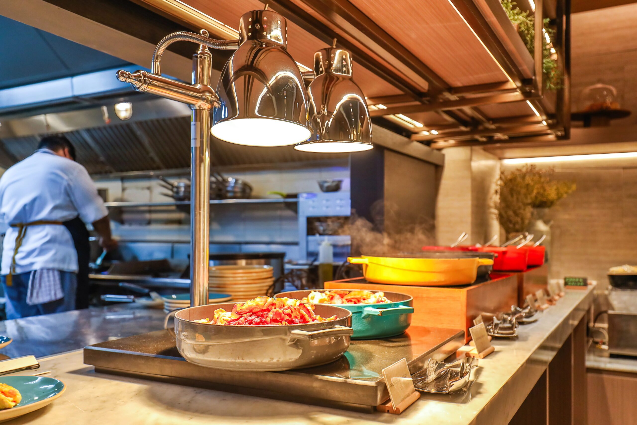 Commercial Kitchen, dishes lined up, chef in background